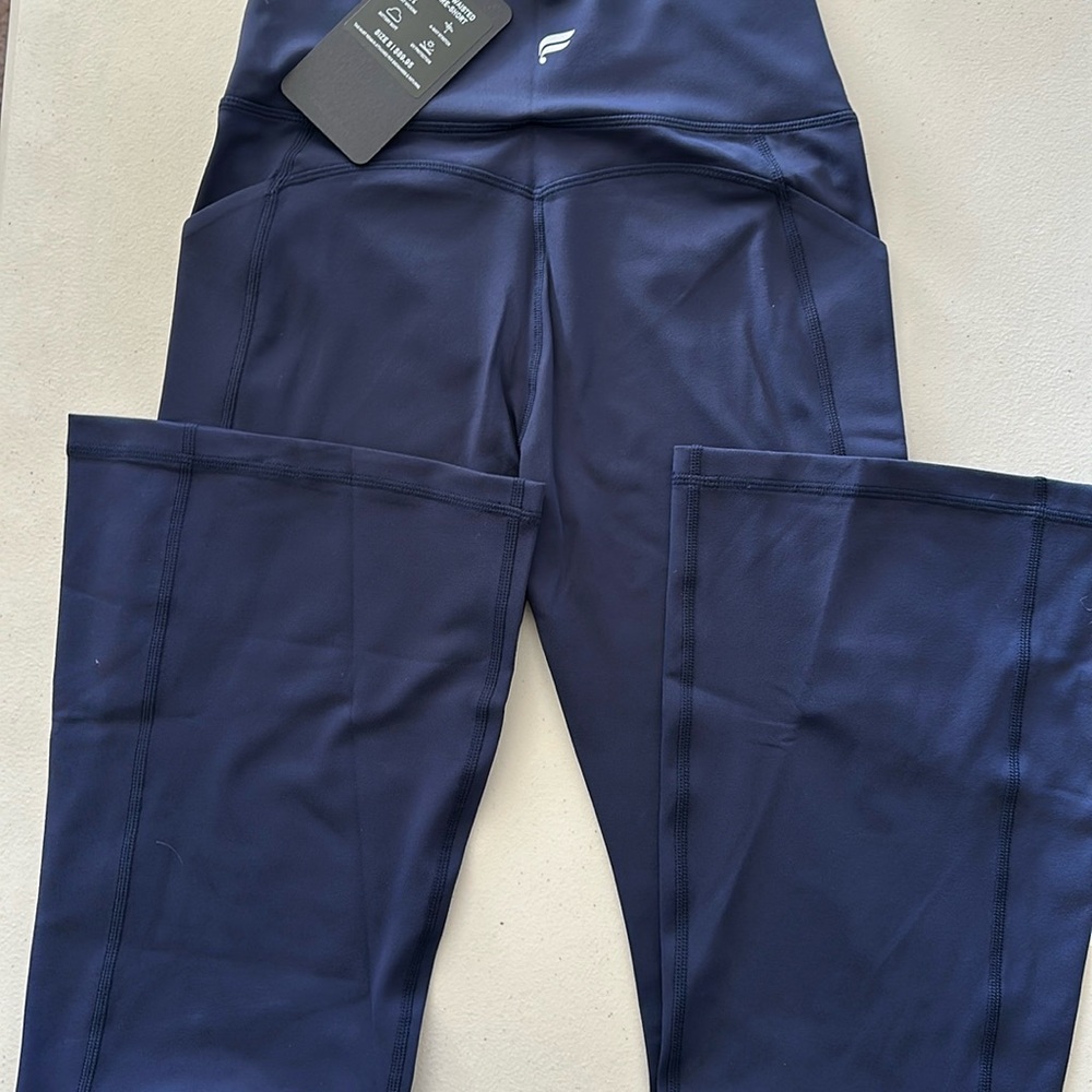 Fabletics long pants with slight flare legs about 10 inches wide on bottom.